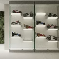Display Cabinet With Glass Door And Model Motorcycles Cars On Shelves By Green Plant Wall
