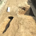 Archaeological Excavation Site With Dug Trenches And Ancient Remains On Dirt Ground