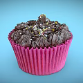 Delicious Chocolate Cupcake With Chocolate Frosting And Colorful Sprinkles In Pink Paper Liner