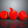 Three Fresh Red Apples on Shiny Reflective Surface with Green Leaf