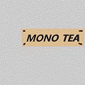 Vibrant Orange Commercial Signage With MONO TEA Lettering Mounted On Wall Surface