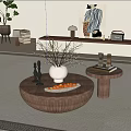 Round Wooden Coffee Table With White Vase Branches Orange Tray And Side Table With Books