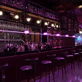 Stylish Bar Interior Design With Purple Lighting Chandeliers Wine Racks And Furniture