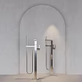 Sleek Silver Faucets With Long Metal Pipes In Arched Niche On Light Gray Wall