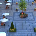 Stylish Outdoor Table With White Umbrellas Green Plants And Benches In Paved Square