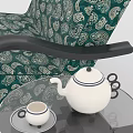 Green Patterned Armchair With Black Armrests And Side Table With Teapot Cups 3d model