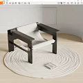 Minimalist Leisure Chair With Dark Frame Light Fabric On Round Woven Rug And Open Book
