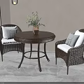 Wicker Table and Chairs Set with Round Table Two Chairs White Cushions and Green Plants