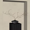 Gray Vase With Slender Branches On Gray Cubic Pedestal Against Beige Wall