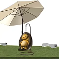 Yellow Inflatable Cartoon Figure Sitting On Hanging Rattan Swing Under Umbrella In Garden