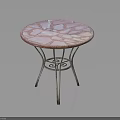 Round Furniture Table with Pink White Patterned Top and Ornate Metal Legs