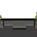 Modern Entrance Gate with Brick Wall and Lush Shrubs Along Illuminated Driveway