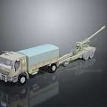 Khaki Military Truck Towing Artillery Cannon On Heavy Duty Trailer With Wheels