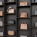 Various Stylish Handbags Displayed On Black Shelves Featuring Brown Black Gray And Quilted Leather Patterns