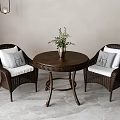Wicker Table and Chairs Set with Round Table Two Chairs White Cushions and Green Plants