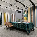 Modern Curtain and Fabric Showroom With Various Colored Fabrics Table Chairs and Plants