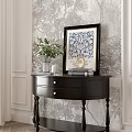 Black Entryway Console Table With Green Plants Framed Art And Candle Decor On Patterned Wallpaper