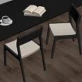 Dining Chairs With Black Frame White Cushion By Table Coffee And Book On Wooden Floor