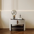 Modern White Leather Nightstand With Glass Globe Lamp Stack Of Books And Beige Wall Lighting