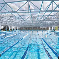 Indoor Swimming Pool with Glass Roof Swimming Lanes Clear Water Steel Structure and Bright Interior