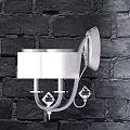 Elegant Modern Wall Sconce With White Shade And Crystal Accents On Brick Wall