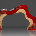 Red Decorative Archway With Welcome Home Banner And Floral Arrangements