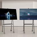 Two Televisions on Wheeled Stands with Apple Logo Display and Windows Logo Screen