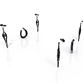 Six Black Metal Hooks And Brackets With Varied Decorative Designs On White Background