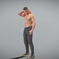 A Shirtless Man Wiping Shoulder With Orange Cloth In Dark Pants And Black Shoes