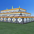 Traditional Multi tiered Religious Building With Blue White Design And Golden Spires On Green Grass