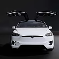 White Tesla Model X With Open Falcon Wing Doors On Dark Background