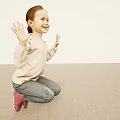 Little Girl With Reddish Brown Hair Waving Hands Kneeling On Light Floor Smiling