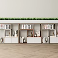 Modern Bookcase with Multiple Compartments Holding Books Decorative Items and Green Grass on Top