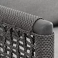 Modern Gray Lounge Chair With Woven Armrests And Black Metal Frame