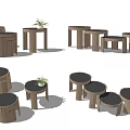Three Wooden Round Side Tables On Woven Rug With Small Plant