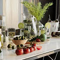 Wine Bottles And Glasses On A Table With Lime Slices Tomatoes Olives And Green Plants