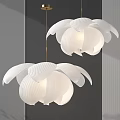 Two White Flower Shaped Chandeliers With Pleated Petals On Dark Wall With Vertical Stripes