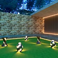 Outdoor Lights On Green Lawn With Modern Twisted Spherical Design Patio Stone Wall Illuminated Evening