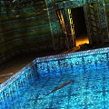 Swimming Pool With Blue Water Tiled Edges And Decorative Architectural Surroundings