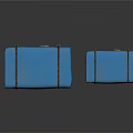 Two Blue Fabric Covered Boxes With Black Straps And Wooden Bases