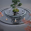 Circular Water Fountain Featuring Central Tree Swan Sculptures Illuminated Lights and Red Maple Trees