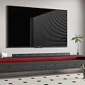 Large Black TV On Modern Gray TV Stand With Red Drawer Cat And Potted Plant