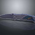 Strider Tactical Folding Knife Featuring Serrated Blade And Metallic Blue Accent Handle