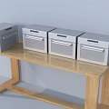 Four Silver Kitchen Appliances Placed On Wooden Table For Kitchen Use