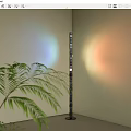 Modern Floor Lamp With Green Plant And Colorful Light Projection On Light Colored Wall