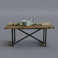 Rustic Wooden Dining Table with Metal Legs Featuring White Plates Green Glasses and Glass Bottle