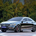 Modern Black Sedan Car With Red Rims Parked On Road Near Green Trees