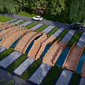 Wooden Landscape Bridge With Connected Structures Amid Green Lawn And Trees