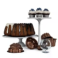 Chocolate Glazed Bundt Cakes and Blueberry Cupcakes on Cake Stands with Baking Molds