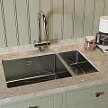 Stainless Steel Double Sink And Faucet On Marble Countertop With Coffee Maker And Cabinets